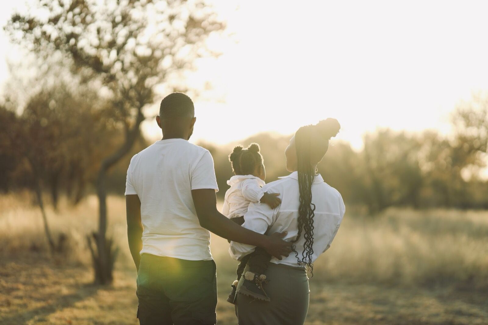 A family walking together through a sunlit park